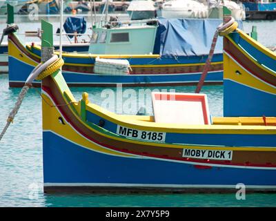 Plusieurs bateaux de pêche colorés se trouvant tranquillement dans le port, de nombreux bateaux de pêche colorés dans un port en Méditerranée, Marsaxlokk, malte Banque D'Images