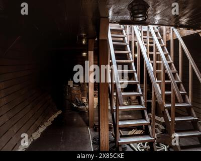 Zone de cargaison intérieure d'un navire historique en bois avec des barils et des cordes, NAO Victoria réplique carrack du navire de Magellan, Séville, Espagne Banque D'Images