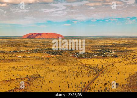 Vue aérienne de la ville de Yulara avec Uluru en arrière-plan Banque D'Images