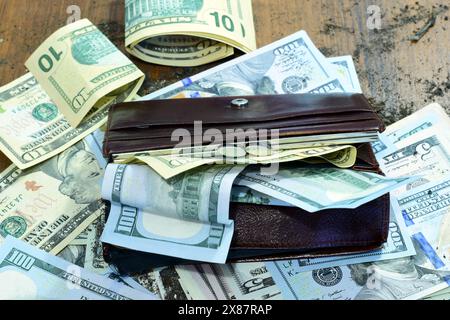 L'argent et un sac à main ouvert gisent dans un désordre sur la table.. Photo de haute qualité Banque D'Images