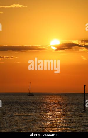 Coucher de soleil doré vu depuis le sentier de la rive de la rivière Wyre à Knott End-on-Sea, Lancashire, regardant au-dessus de l'estuaire de la rivière Wyre à marée haute le 19 mai 2024. Banque D'Images