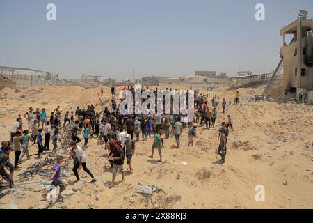 Gaza. 23 mai 2024. Les gens se bousculent pour obtenir de l’aide humanitaire larguée par un avion dans la ville de Khan Younis, dans le sud de la bande de Gaza, le 23 mai 2024. La majorité de la population de la bande de Gaza souffre d'un manque de nourriture, de médicaments et de besoins humanitaires de base depuis le début de la guerre. Les agences des Nations Unies ont mis en garde contre les conséquences désastreuses dans l'enclave, notamment la famine et la propagation des épidémies et des maladies parmi la population locale. Crédit : Rizek Abdeljawad/Xinhua/Alamy Live News Banque D'Images