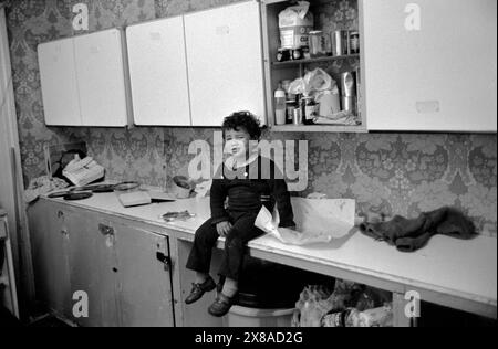 Chiswick Women's Aid, Richmond, Londres, Angleterre vers novembre 1975. Un jeune garçon pleure assis sur le comptoir de la cuisine. 1970S UK HOMER SYKES Banque D'Images