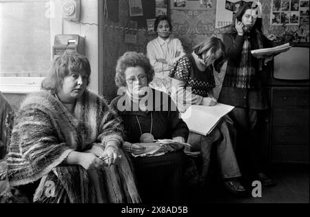 Chiswick Women's Aid, Erin Pizzey et la co-fondatrice Anne Ashby (lunettes) lors d'une réunion Daily House. Les femmes ont pu discuter de leurs problèmes et des questions auxquelles elles étaient confrontées avec les fondatrices et les autres femmes du refuge. D'autres assistants au téléphone et prenant des notes afin que les problèmes puissent faire l'objet d'un suivi. Richmond, Londres, Angleterre novembre 1975. ANNÉES 1970 ROYAUME-UNI HOMER SYKES. Banque D'Images