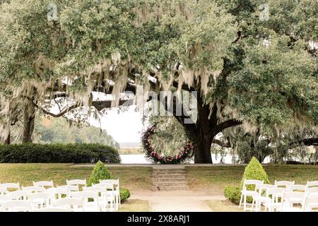 Configuration de cérémonie de mariage en plein air sous le chêne avec arc floral Banque D'Images