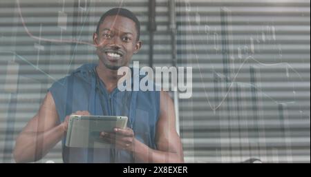 Image du traitement des données statistiques sur l'homme de forme afro-américain utilisant la tablette numérique à la salle de gym Banque D'Images