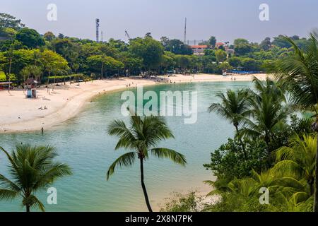 SINGAPOUR - 08 AVRIL 2024 : sable doré et végétation luxuriante sur la plage tropicale de Palawan sur l'île de Sentosa, Singapour Banque D'Images
