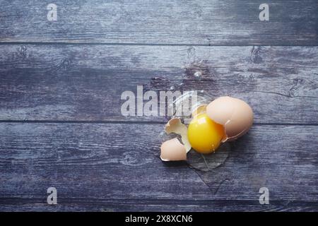 Oeuf cassé frais sur la table en bois Banque D'Images
