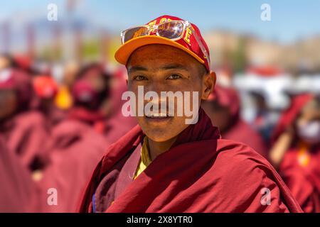 Portrait d'un jeune moine bouddhiste de Leh, Ladakh portant une casquette et une robe rouge monastique. 23 mai 2024. Banque D'Images