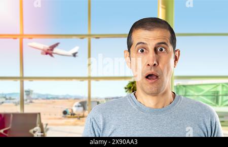 Portrait d'un jeune homme choqué à l'aéroport. Banque D'Images