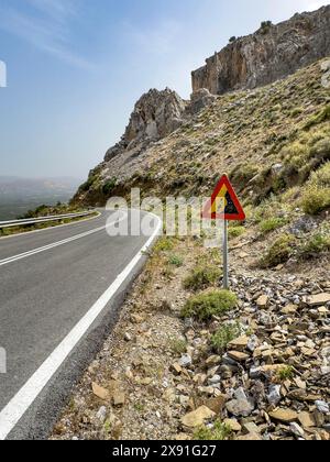 Panneau d'avertissement pour la chute de rochers à côté de la route de montagne près de Plora dans les montagnes rocheuses en arrière-plan, Crète, Grèce Banque D'Images