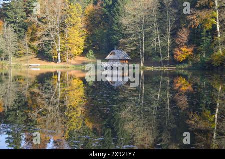 Chalet en bois sur le lac Trakoscan. Couleurs d'automne, reflet dans l'eau Banque D'Images