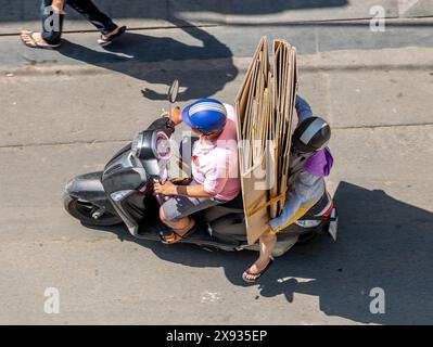 Un couple transporte des cartons de papier dépliés sur une moto, Ho Chi Minh ville, Vietnam. Banque D'Images