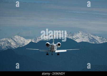 Avion en vol sur fond de montagnes enneigées. L'avion se prépare à atterrir Banque D'Images