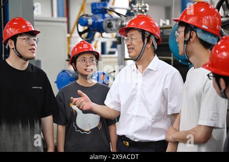 (240530) -- CHENGDU, 30 mai 2024 (Xinhua) -- Zhong Yuanzhang (3e l) communique avec des collègues sur une plate-forme expérimentale à l'Institut de l'énergie nucléaire de Chine à Chengdu, dans la province du Sichuan, au sud-ouest de la Chine, le 24 mai 2024. Zhong était le concepteur en chef adjoint du projet d'énergie nucléaire Hualong de l'Institut de l'énergie nucléaire de Chine. Depuis qu'il a obtenu son diplôme de l'Université des sciences et de la technologie de Chengdu (aujourd'hui Université du Sichuan) avec spécialisation en génie chimique en 1986, Zhong s'est engagé dans la conception de structures de réacteurs et a participé à la R&d de plus de la moitié de la puissance nucléaire chinoise Banque D'Images