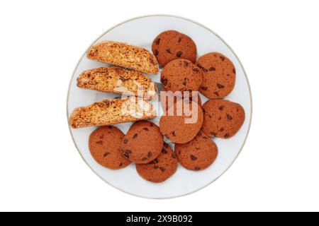 Biscotti et biscuits aux pépites de chocolat sur une assiette isolée sur un fond blanc. Vue de dessus. Banque D'Images