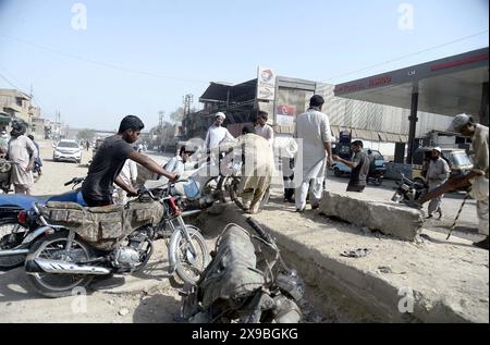 Les navetteurs ont été inquiets et confrontés à des problèmes en raison de la fermeture de la route lors de la manifestation de protestation des résidents de Shershah Colony contre le délestage prolongé de la charge d'électricité par temps chaud de la saison estivale, sur Shershah Road à Karachi le jeudi 30 mai 2024. Banque D'Images