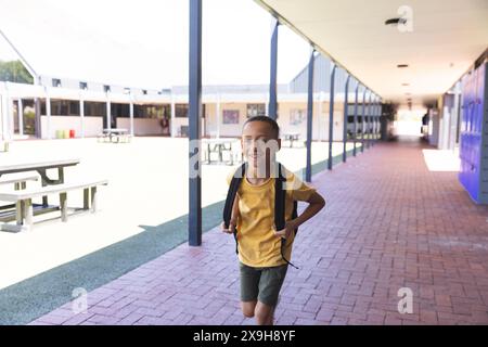 Garçon biracial sourit brillamment à l'école Banque D'Images