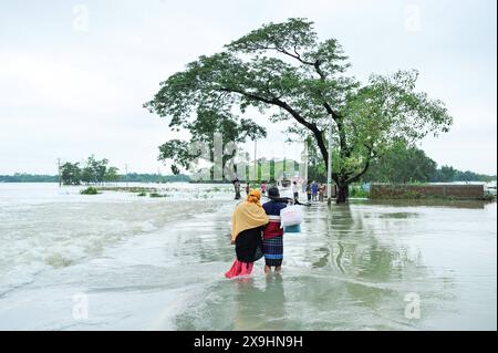 Le cyclone Remal frappe les Sylhet qui luttent pour traverser la route principale inondée de Lafnaut, dans la région de Goanghat upazila, en raison des fortes pluies après que le cyclone Remal a frappé le Bangladesh. Le 30 mai 2024 à Sylhet, Bangladesh. Sylhet Sylhet Bangladesh Copyright : xMdxRafayatxHaquexKhanxxEyepixxGrx Banque D'Images