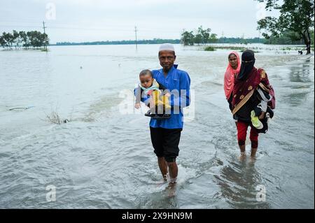 Le cyclone Remal frappe les Sylhet qui luttent pour traverser la route principale inondée de Lafnaut, dans la région de Goanghat upazila, en raison des fortes pluies après que le cyclone Remal a frappé le Bangladesh. Le 30 mai 2024 à Sylhet, Bangladesh. Sylhet Sylhet Bangladesh Copyright : xMdxRafayatxHaquexKhanxxEyepixxGrx Banque D'Images