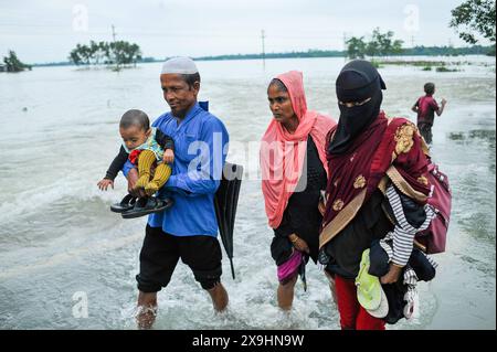 Le cyclone Remal frappe les Sylhet qui luttent pour traverser la route principale inondée de Lafnaut, dans la région de Goanghat upazila, en raison des fortes pluies après que le cyclone Remal a frappé le Bangladesh. Le 30 mai 2024 à Sylhet, Bangladesh. Sylhet Sylhet Bangladesh Copyright : xMdxRafayatxHaquexKhanxxEyepixxGrx Banque D'Images