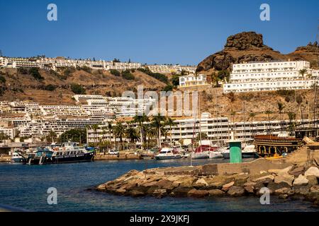 Puerto Rico, Gran Canaria, Espagne : vue de la station balnéaire Puerto Rico, sud de Gran Canaria, Espagne avec de grands bâtiments hôteliers sur les collines et la plage Banque D'Images