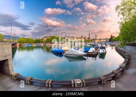 Vue panoramique sur Fraumunster et l'église St Peters avec des bateaux amarrés à Zurich, Suisse Banque D'Images