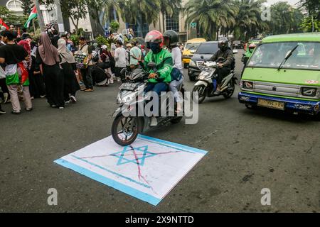 Bogor, Indonésie. 01 juin 2024. Une balade de motocycliste au-dessus des drapeaux israéliens lors d'une manifestation pro-palestinienne à Bogor, Java Ouest, Indonésie, le 1er juin 2024, contre l’attaque israélienne contre le camp de réfugiés palestiniens de Rafah, qui a tué de nombreuses personnes. (Photo par Andi M Ridwan/INA photo Agency/SIPA USA) crédit : SIPA USA/Alamy Live News Banque D'Images