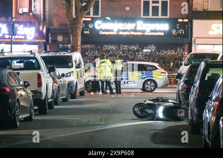 North Road, Selly Oak, Birmingham, 2 juin 2024 - la police des West Midlands lance un appel pour obtenir des informations après qu'un homme a été retrouvé avec des blessures graves sur Bristol Road, Selly Oak la nuit dernière (1er juin). L'homme de 32 ans a été transporté à l'hôpital dans un état grave. Un policier médico-légal a été photographié en train d'enregistrer la scène et de retirer un fendeur à viande d'un bac commercial. L'agent de CSI a également prélevé des prélèvements de sang trouvés sur un véhicule et une autre substance sur un autre. Un cyclomoteur blanc se trouvait près de l'endroit où le grand couteau a été découvert et a été enlevé par la lumière du jour. Crédit : arrêtez Press Media/Alamy Live News Banque D'Images