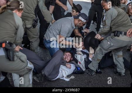 Bnei Brak, Israël. 02 juin 2024. Les policiers israéliens éloignent les manifestants ultra-orthodoxes qui bloquent une route à Bnei Brak, lors d’une manifestation contre d’éventuels changements de lois exemptant les hommes ultra-orthodoxes de la conscription militaire. Crédit : Ilia Yefimovich/dpa/Alamy Live News Banque D'Images