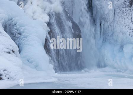 . Cascade Helgufoss couverte de glace au début du printemps. Islande Banque D'Images