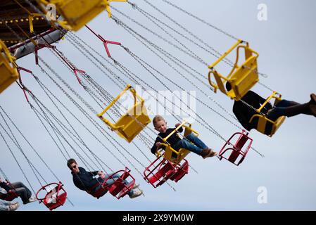 Personnes sur la chair-o-planes à la foire funfair à la 81e réunion des membres, Goodwood Motor Racing circuit, Chichester, Royaume-Uni Banque D'Images