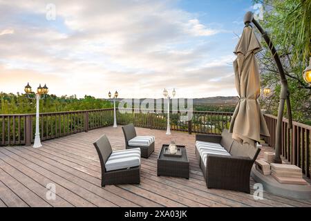 Une terrasse avec divers meubles marron et un parasol à Encino, CA Banque D'Images