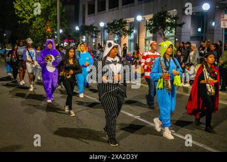 Une fanfare multiraciale costumée participe à un défilé nocturne d'Halloween à Anaheim, EN CALIFORNIE. Banque D'Images