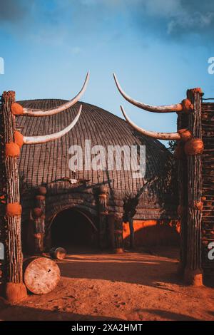 Cette superbe photographie capture une cabane tribale à l'architecture africaine spectaculaire en Afrique du Sud, avec des détails complexes et des couleurs vives. IDE Banque D'Images