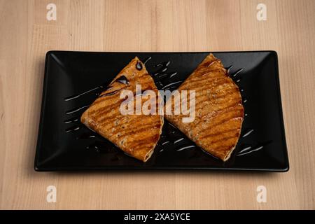 Un gros plan de crêpes garnies de sirop sur une assiette servie sur une table Banque D'Images