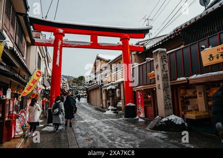 Les adorateurs japonais et les touristes à l'ancienne porte japonaise et les temples couverts de neige rare d'hiver au sanctuaire Fushimi Inari à Kyoto Japon. Banque D'Images