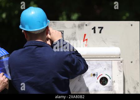 Électricien professionnel travaillant sur un appareil industriel à partir d'une centrale électrique. Banque D'Images