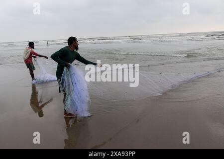 5 juin 2024, Cox's Bazar, Chittagong, Bangladesh : les pêcheurs capturent des poissons avec des filets de pêche à Cox's Bazar Sea Beach, Bangladesh. Le gagne-pain de la communauté des pêcheurs ici dépend largement de la pêche. Cox's Bazar, la plus longue plage marine naturelle du monde, s'étend sur plus de 120 kilomètres le long de la côte sud-est du Bangladesh. Réputée pour son sable doré, ses couchers de soleil vibrants et ses vagues, elle attire des millions de touristes chaque année. (Crédit image : © Joy Saha/ZUMA Press Wire) USAGE ÉDITORIAL SEULEMENT! Non destiné à UN USAGE commercial ! Banque D'Images