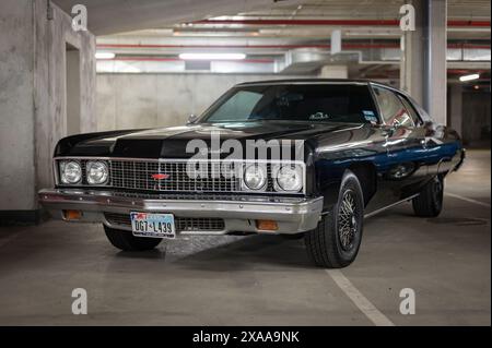 Vue de face d'une impressionnante voiture de sport américaine garée dans un parking, il s'agit d'une Chevrolet Impala noire classique de cinquième génération Banque D'Images