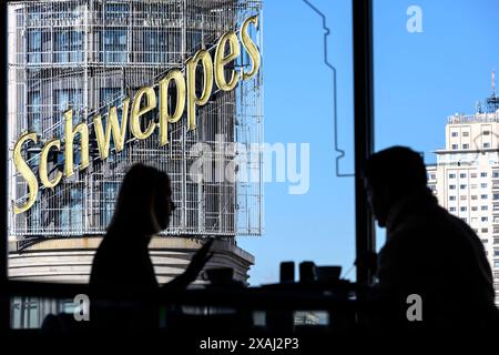 Le panneau publicitaire Schweppes sur le bâtiment Carrion vu d'un café dans la salle de restauration du centre commercial El Corte Ingles sur la Plaza de Callao, Banque D'Images