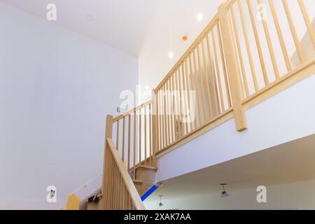 Les mains courantes en bois ainsi que les garde-corps escaliers avec dans la nouvelle maison sont conçus de style classique Banque D'Images