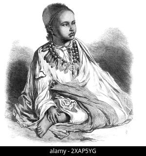 Dejatch Alamaeo, fils de Théodore, défunt roi d'Abyssinie, 1868. Le infant...now à la fois sans père et sans mère,... est nommé Alamaeo ou Allumahyu (comme il est parfois écrit), ce qui signifie dans la langue amharique "j'ai vu le monde." Mais ce pauvre petit orphelin, qui n'a que sept ans, né en juin 1861, en a vu très peu. Il en verra cependant beaucoup plus que son père ne l'a jamais fait, puisqu'il sera éduqué par le Dr Wilson au Mission College de Bombay. Il porte le titre de Dejatch, qui est Prince ou Duc ; son étymologie se réfère à la baguette Banque D'Images