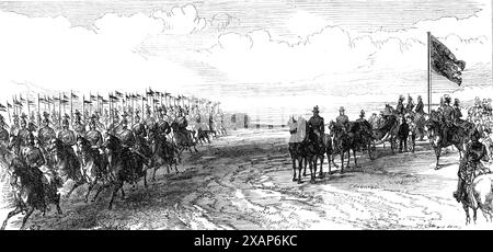 Visite du Prince et de la Princesse de Galles en Irlande : revue à Phoenix Park [à Dublin] : le 12e Lancers galoping Past, 1868. '...un beau spectacle militaire. Le prince et la princesse sont venus sur le sol vers une heure ; il était à cheval, et elle était dans une voiture ouverte et quatre... quand ils entraient, les armes s'ouvraient avec un salut royal, et "Dieu sauve la Reine" de nombreuses bandes a été entendu au-dessus des cris du peuple. Le duc de Cambridge, dans l'uniforme d'un maréchal,... chevauchait près du prince de Galles, qui portait... l'uniforme du 10e hussards, et le prince Teck, qui portait le sien Banque D'Images