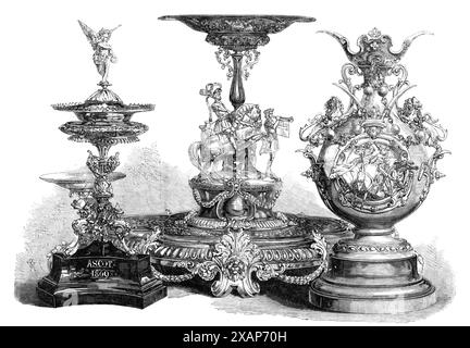 Assiette de prix des courses Ascot : la Royal Hunt Cup, la Ascot Cup, la Queen's Gold Cup, 1869. 'Trois des belles pièces d'assiette faites pour les prix de cette année aux courses Ascot... la Coupe Ascot n'est pas une tasse proprement dite, mais un ornement de table, ou "surtout de table", consistant en un stand en argent, portant une grande tazza pour les fleurs, au centre, et à chaque extrémité un plus petit pour les fruits. Devant la tige centrale se trouve un groupe équestre, représentant le chevalier champion à cheval, avec son écuyer ou page soufflant une note de défi sur la corne. Le tout est richement orné, moi Banque D'Images