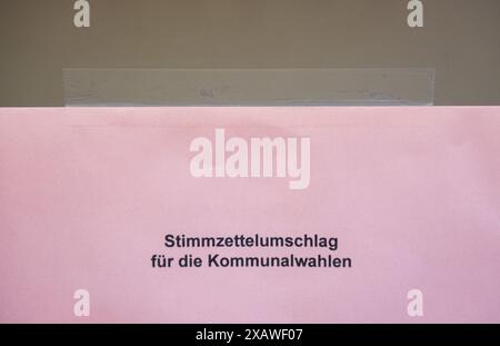 Rottweil, Allemagne. 09 juin 2024. Un morceau de papier portant l'inscription « enveloppe de papier de vote pour les élections locales » est accroché à une urne dans un bureau de vote du quartier Rottweiler de Göllsdorf. Outre les élections européennes, des élections locales sont également organisées dans le Bade-Württemberg. Crédit : Silas Stein/dpa/Alamy Live News Banque D'Images