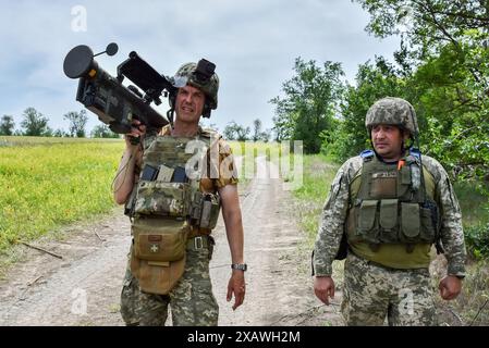 28 mai 2024, Orikhiv, Zaporizhzhia, Ukraine : des militaires ukrainiens (unité de défense aérienne) marchent sur la route avec un lance-missiles de défense aérienne américain Stinger sur la ligne de front dans la région de Zaporizhzhia. Le département américain de la Défense a annoncé un nouveau paquet d'aide militaire pour l'Ukraine. Ce paquet Presidential Drawdown Authority a une valeur estimée à 225 millions de dollars. Le dernier paquet de mesures de défense fournira à l’Ukraine des capacités supplémentaires pour répondre à ses besoins les plus urgents sur le champ de bataille, telles que des intercepteurs de défense aérienne, des systèmes d’artillerie et des munitions, des véhicules blindés et des armes antichars. (Crédit Banque D'Images