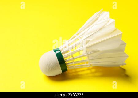 Un volant de badminton de plume sur fond jaune Banque D'Images