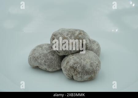 Mochi avec poudre blanche avec remplissage de chocolat et fond blanc Banque D'Images