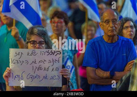 Haïfa, Israël - 08 juin 2024 : foule de personnes avec divers signes et drapeaux dans une Assemblée protester contre le gouvernement, appelant à de nouvelles élections. Banque D'Images